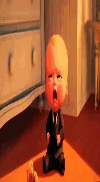 a cartoon character from the boss baby is laying on a bed .