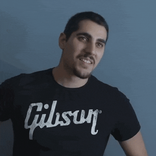a man wearing a black shirt that says gibson