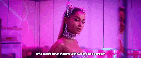 ariana grande is wearing a purple dress and a purple headband and earrings .