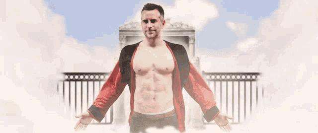 a shirtless man with his arms outstretched in front of a building