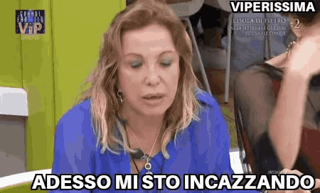 a woman in a blue shirt says adesso mi sto incazzano