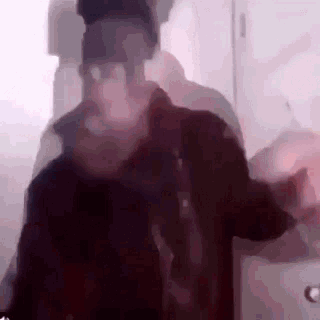 a blurry picture of a person standing in a doorway