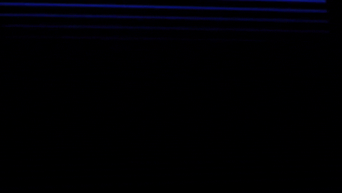a silhouette of a person standing in front of a blue striped background .