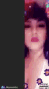 a close up of a woman 's face with a black background .
