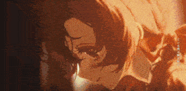 a close up of a person 's face with a blurred background and a flame in the background .