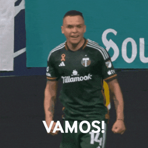 a soccer player wearing a green tillamook jersey