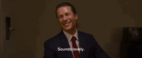 a man in a suit and tie is smiling and saying sounds lovely