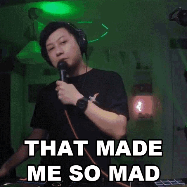 a man wearing headphones and holding a microphone with the words that made me so mad below him