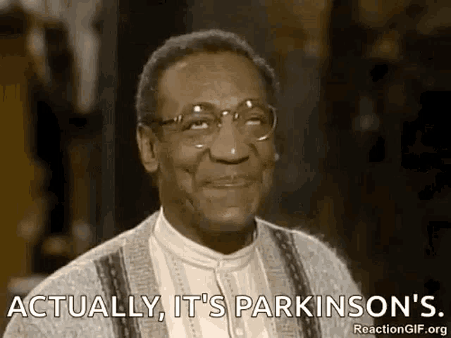 a man wearing glasses is smiling and saying `` actually , it 's parkinson 's . ``