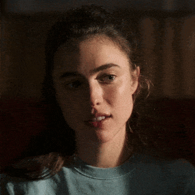 a close up of a woman 's face making a funny face