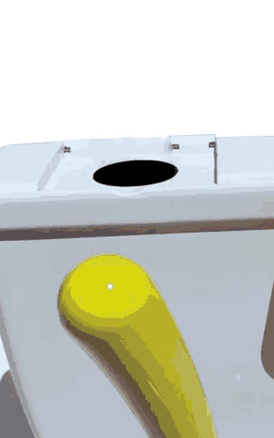 a white toilet with a yellow handle and a hole in the top