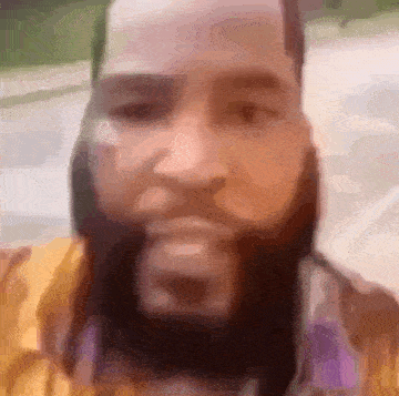 a man with a beard is making a funny face .