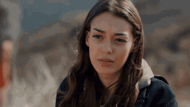 a close up of a woman 's face with a serious expression