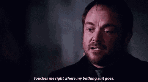 a man with a beard is talking and says " touches me right where my bathing suit goes "