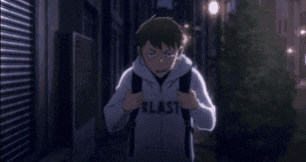 a close up of a person 's face with a hoodie on looking at the camera .