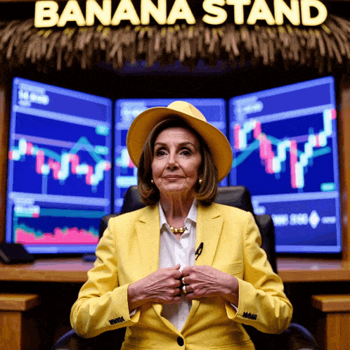 a woman in a yellow jacket and hat sits under a banana stand