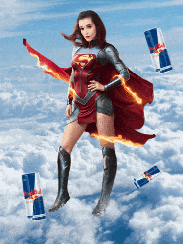 a woman in a superman costume with red bull cans in the background