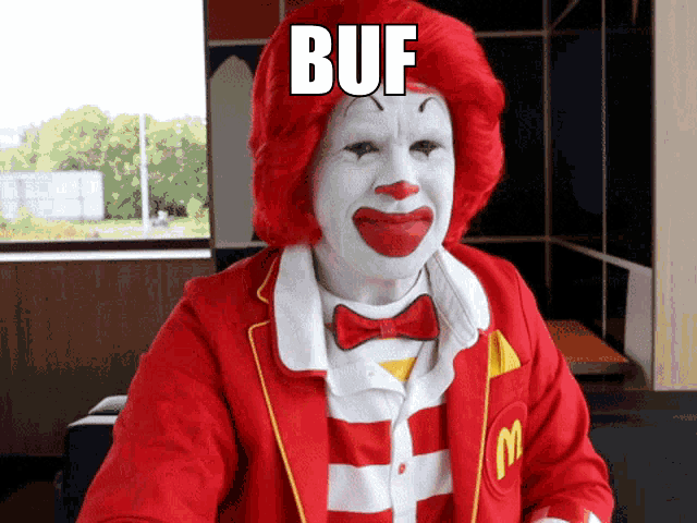 a mcdonald 's clown with red hair and white face has the word buf above his head