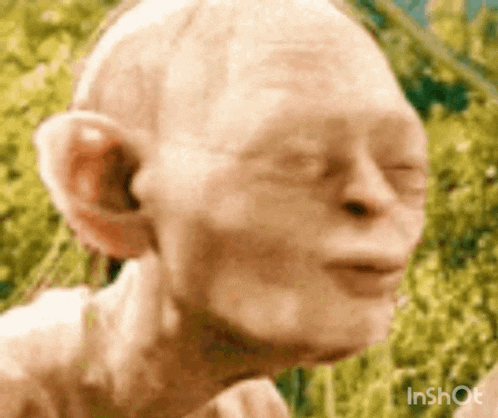 a close up of a statue of gollum from the lord of the rings .