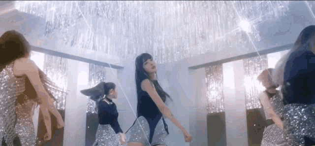 a group of women are dancing in a room .