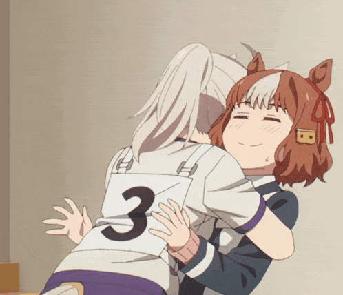 a girl hugging another girl with the number 3 on her back