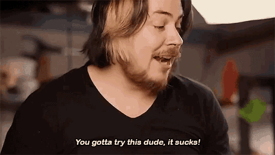 a man in a black shirt says you gotta try this dude it sucks