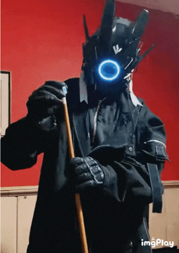 a man in a futuristic costume holds a pool cue