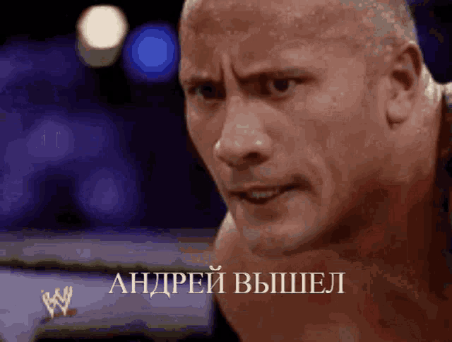 a man 's face is shown in a wrestling ring with a w logo on the bottom