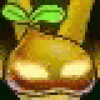 a close up of a yellow object with a green leaf on it .