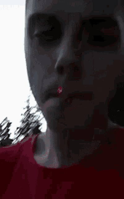a close up of a person smoking a cigarette