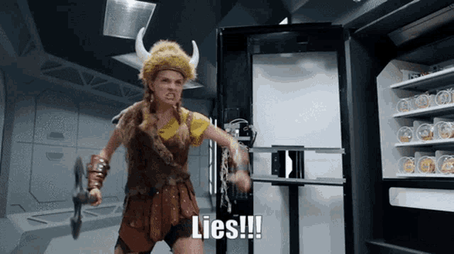 a woman in a viking costume is holding a sword and says lies !!!