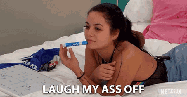 a woman is laying on a bed with the words " laugh my ass off " written on the bottom