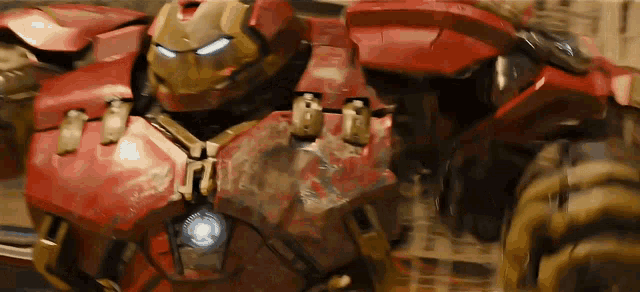a close up of a red robot with a light on the front