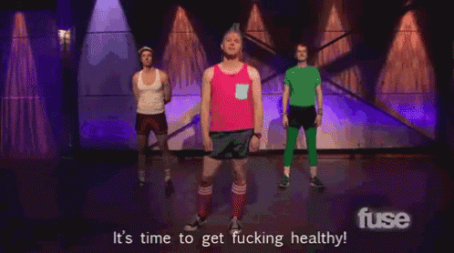 a group of men standing on a stage with the words " it 's time to get fucking healthy " on the bottom