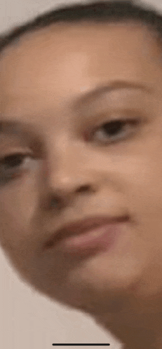 a close up of a woman 's face looking at the camera .