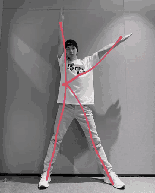 a man wearing a white shirt that says the dancing king