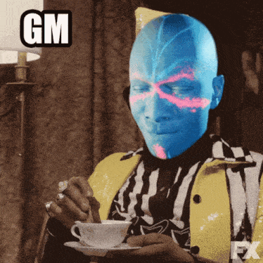 a man with a blue face is drinking from a cup and saucer with a gm sticker above him