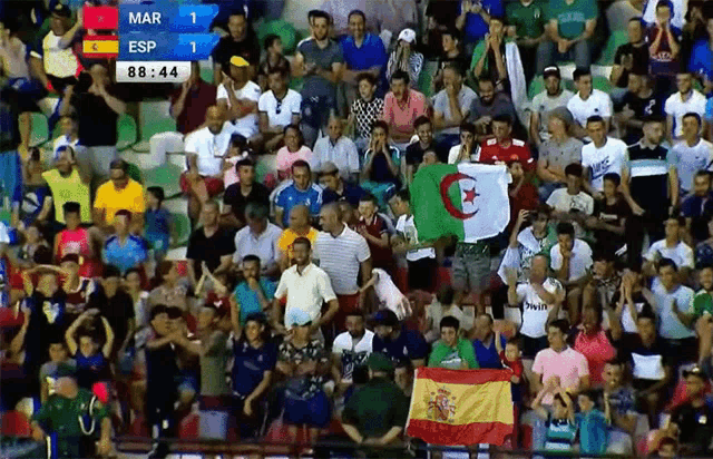 a crowd of people watching a soccer game with a scoreboard that says mar esp