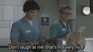 two nurses are standing next to each other in a hospital room .