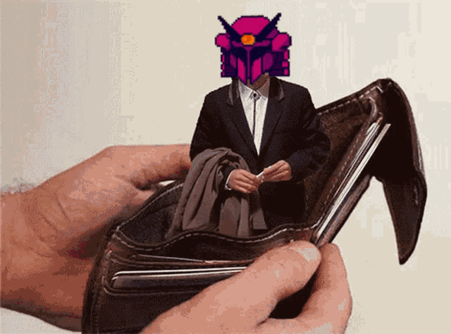 a person is holding an empty wallet with a man in a suit sitting inside of it