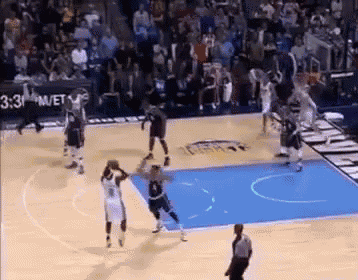 a basketball game is being played on a court with a referee .