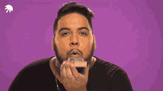 a man blowing smoke in front of a purple background that says boys do it joo