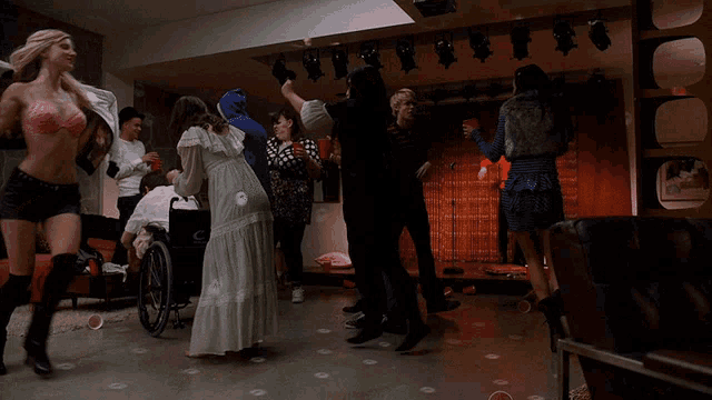 a group of people are dancing in a room