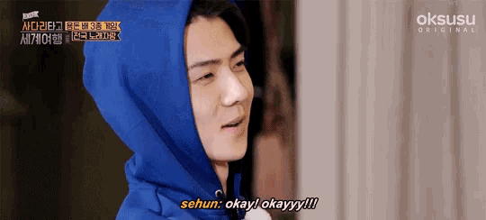a man in a blue hoodie says sehun okay okayy !!!