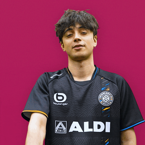 a man wearing a black shirt with the word aldi on the front