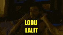 a man is laying on a bed with the words lodu lalit written in yellow