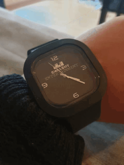 a person wearing a watch that says chillout entertainment
