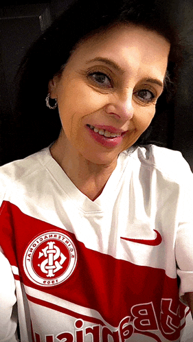 a woman is wearing a red and white jersey with the year 2001 on the front