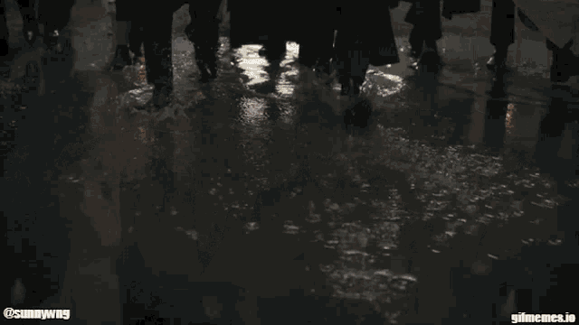 a group of men in suits and hats are walking down a street with the watermark @sunnyway