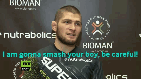 a man stands in front of a sign that says bioman on it